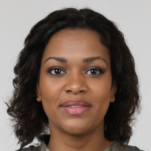 Joyful black young-adult female with medium  black hair and brown eyes