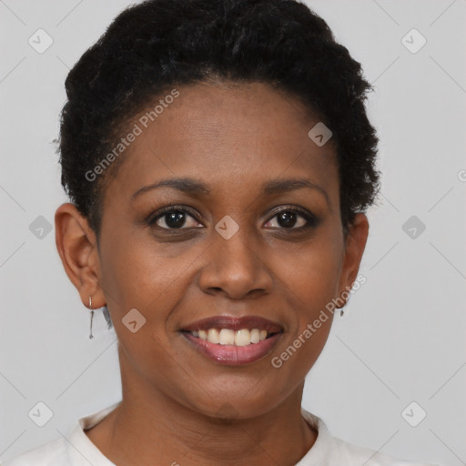 Joyful black young-adult female with short  black hair and brown eyes