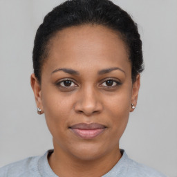 Joyful black young-adult female with short  brown hair and brown eyes