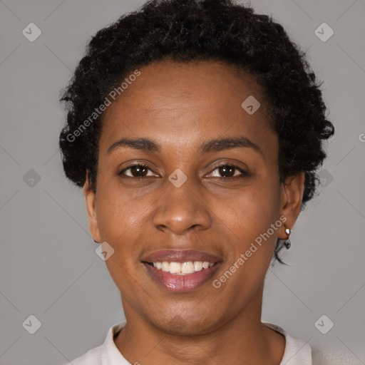 Joyful black young-adult female with short  brown hair and brown eyes