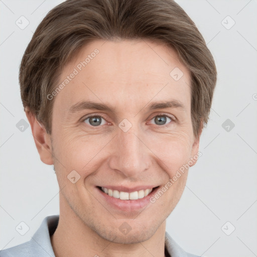 Joyful white adult male with short  brown hair and grey eyes