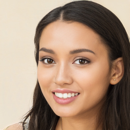 Joyful latino young-adult female with long  black hair and brown eyes