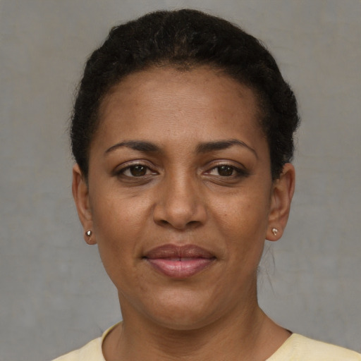 Joyful black adult female with short  brown hair and brown eyes