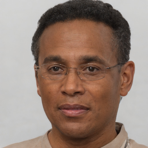Joyful black adult male with short  black hair and brown eyes