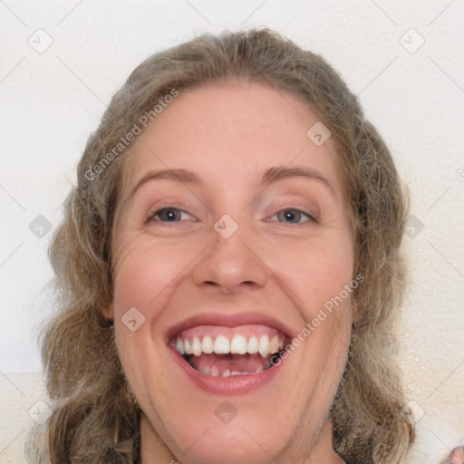 Joyful white adult female with medium  brown hair and blue eyes