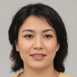 Joyful asian young-adult female with medium  brown hair and brown eyes