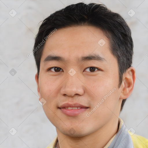 Joyful asian young-adult male with short  black hair and brown eyes