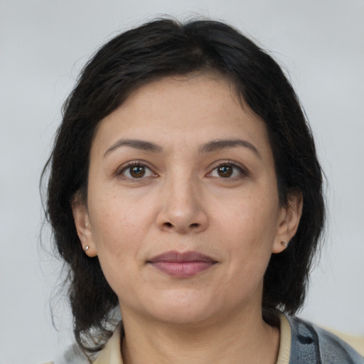 Joyful asian adult female with medium  brown hair and brown eyes