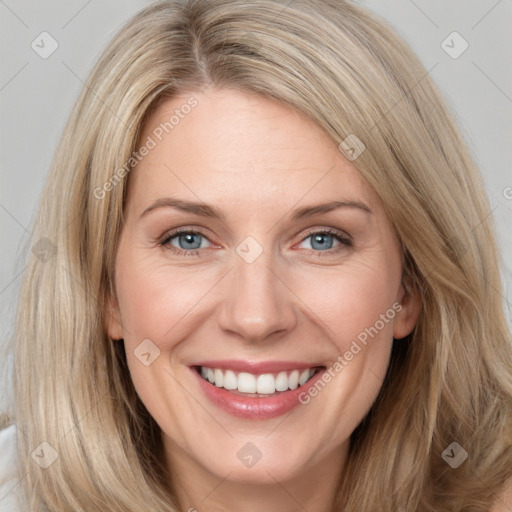 Joyful white adult female with long  brown hair and grey eyes