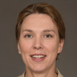 Joyful white adult female with short  brown hair and grey eyes