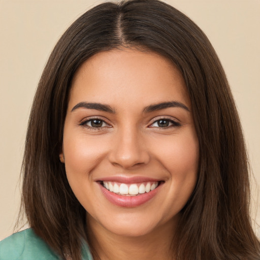 Joyful white young-adult female with long  brown hair and brown eyes