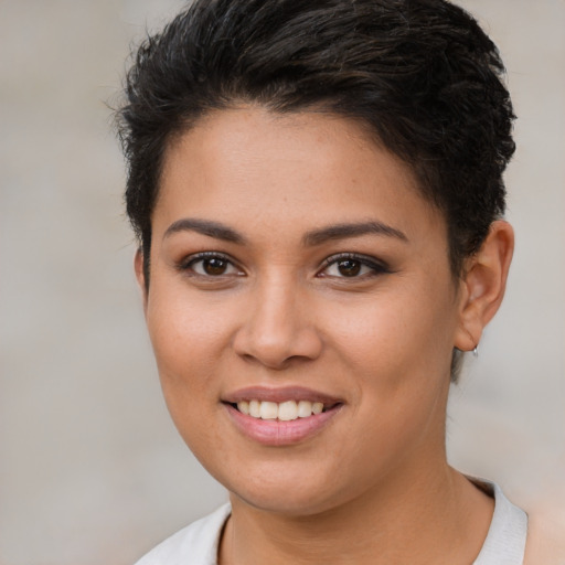 Joyful latino young-adult female with short  brown hair and brown eyes