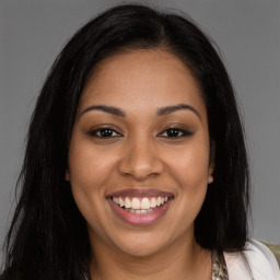 Joyful latino young-adult female with long  brown hair and brown eyes