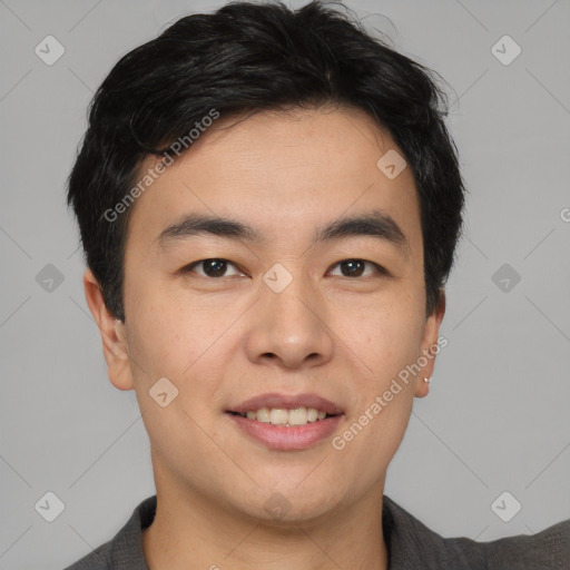 Joyful asian young-adult male with short  brown hair and brown eyes