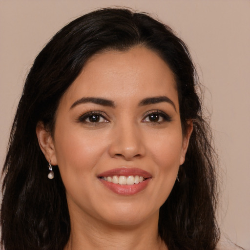 Joyful latino young-adult female with long  brown hair and brown eyes