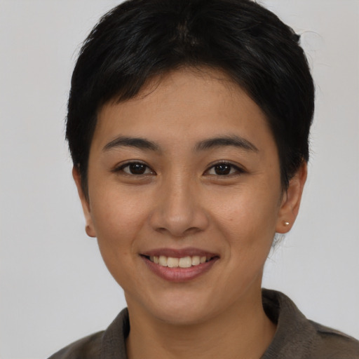 Joyful asian young-adult female with short  black hair and brown eyes