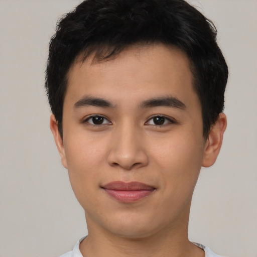 Joyful asian young-adult male with short  brown hair and brown eyes