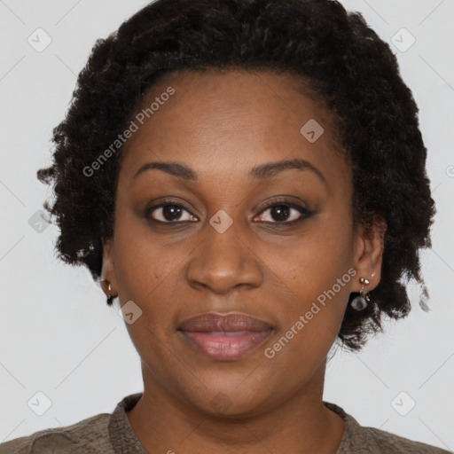 Joyful black adult female with short  brown hair and brown eyes