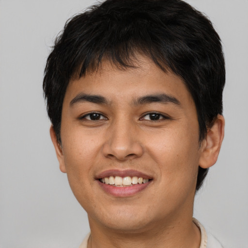 Joyful asian young-adult male with short  brown hair and brown eyes