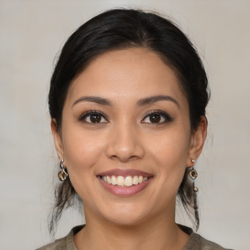 Joyful latino young-adult female with medium  brown hair and brown eyes