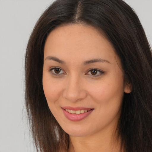 Joyful white young-adult female with long  brown hair and brown eyes