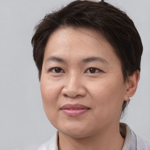 Joyful white adult female with short  brown hair and brown eyes