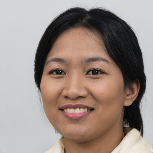 Joyful asian young-adult female with medium  black hair and brown eyes