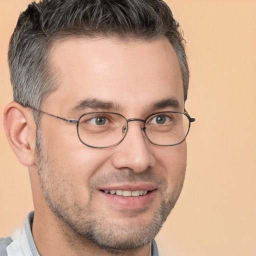 Joyful white adult male with short  brown hair and brown eyes