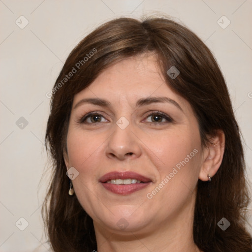 Joyful white adult female with long  brown hair and brown eyes