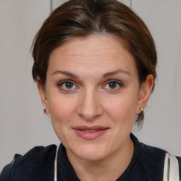 Joyful white adult female with medium  brown hair and brown eyes