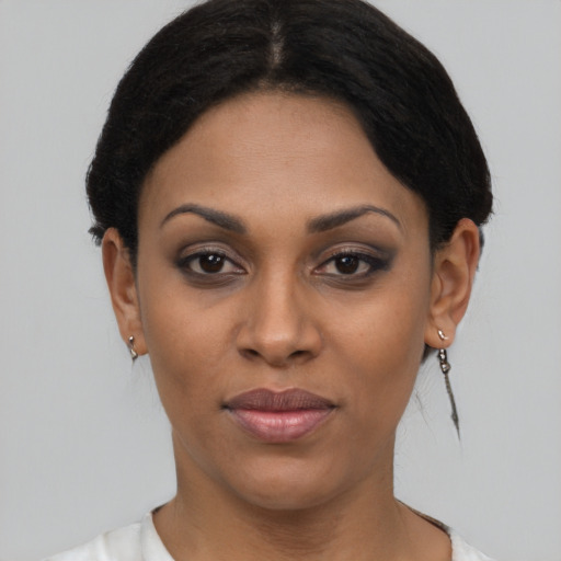 Joyful latino young-adult female with short  brown hair and brown eyes