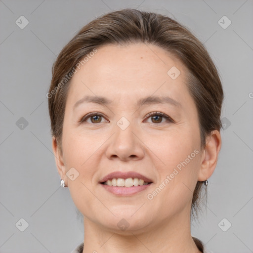 Joyful white adult female with medium  brown hair and grey eyes