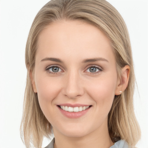 Joyful white young-adult female with long  brown hair and blue eyes