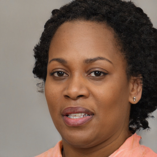 Joyful black young-adult female with medium  brown hair and brown eyes