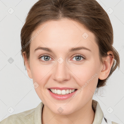 Joyful white young-adult female with medium  brown hair and grey eyes