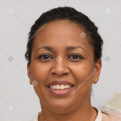 Joyful black young-adult female with short  brown hair and brown eyes