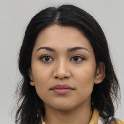 Joyful latino young-adult female with long  brown hair and brown eyes