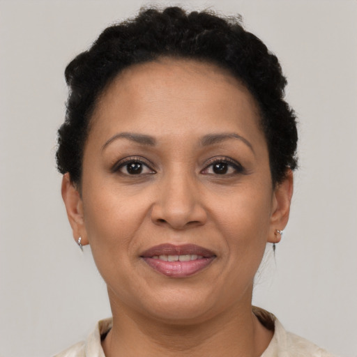 Joyful latino adult female with short  brown hair and brown eyes