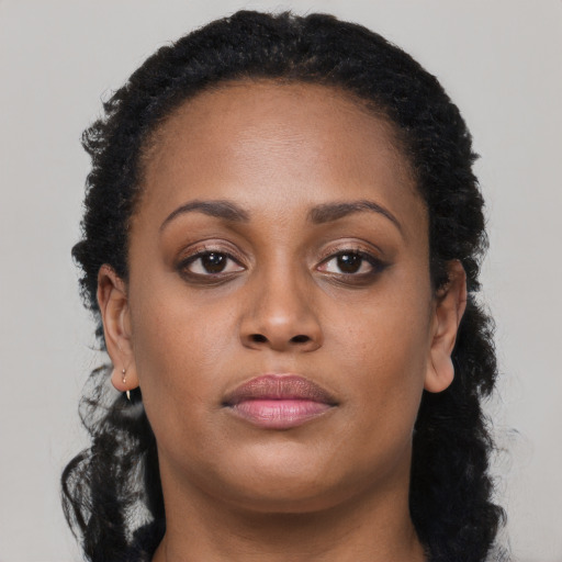 Neutral black young-adult female with long  brown hair and brown eyes