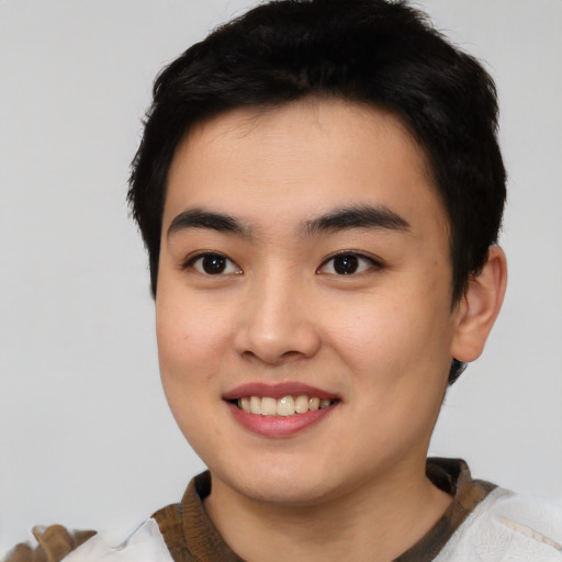 Joyful asian young-adult male with short  black hair and brown eyes