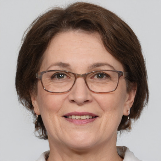 Joyful white middle-aged female with medium  brown hair and brown eyes