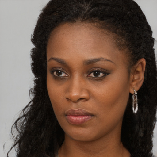 Neutral black young-adult female with long  brown hair and brown eyes