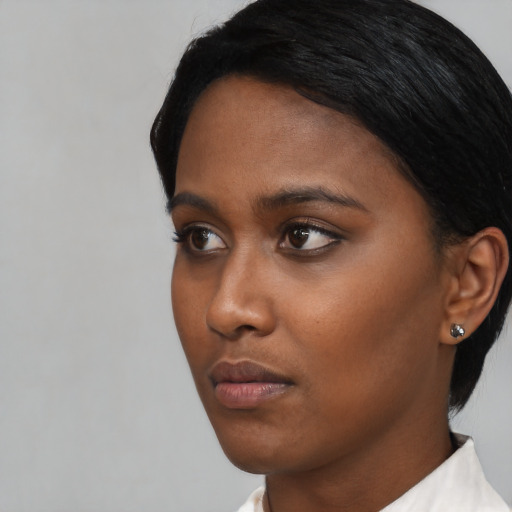 Neutral black young-adult female with short  black hair and brown eyes