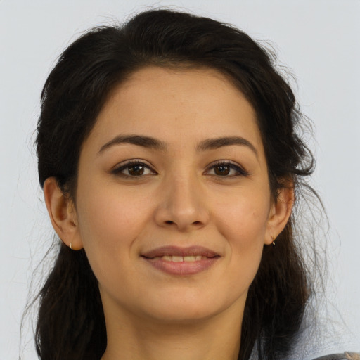Joyful latino young-adult female with long  brown hair and brown eyes