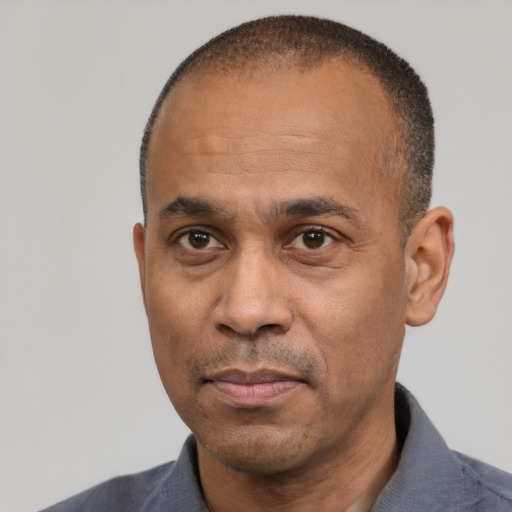 Neutral latino adult male with short  black hair and brown eyes