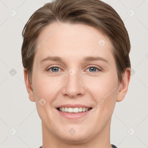 Joyful white young-adult female with short  brown hair and grey eyes