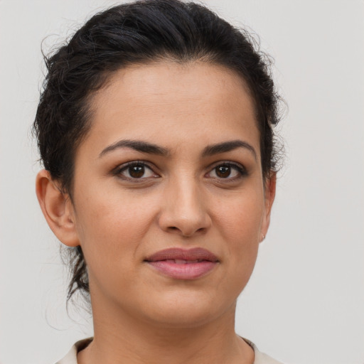 Joyful latino young-adult female with short  brown hair and brown eyes