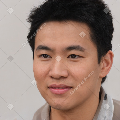 Joyful asian young-adult male with short  brown hair and brown eyes