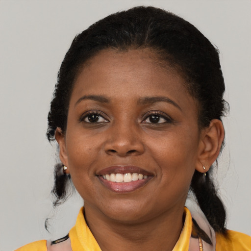 Joyful black young-adult female with medium  black hair and brown eyes