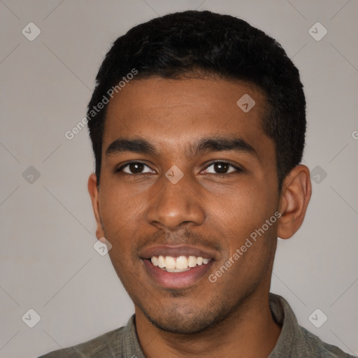 Joyful black young-adult male with short  black hair and brown eyes